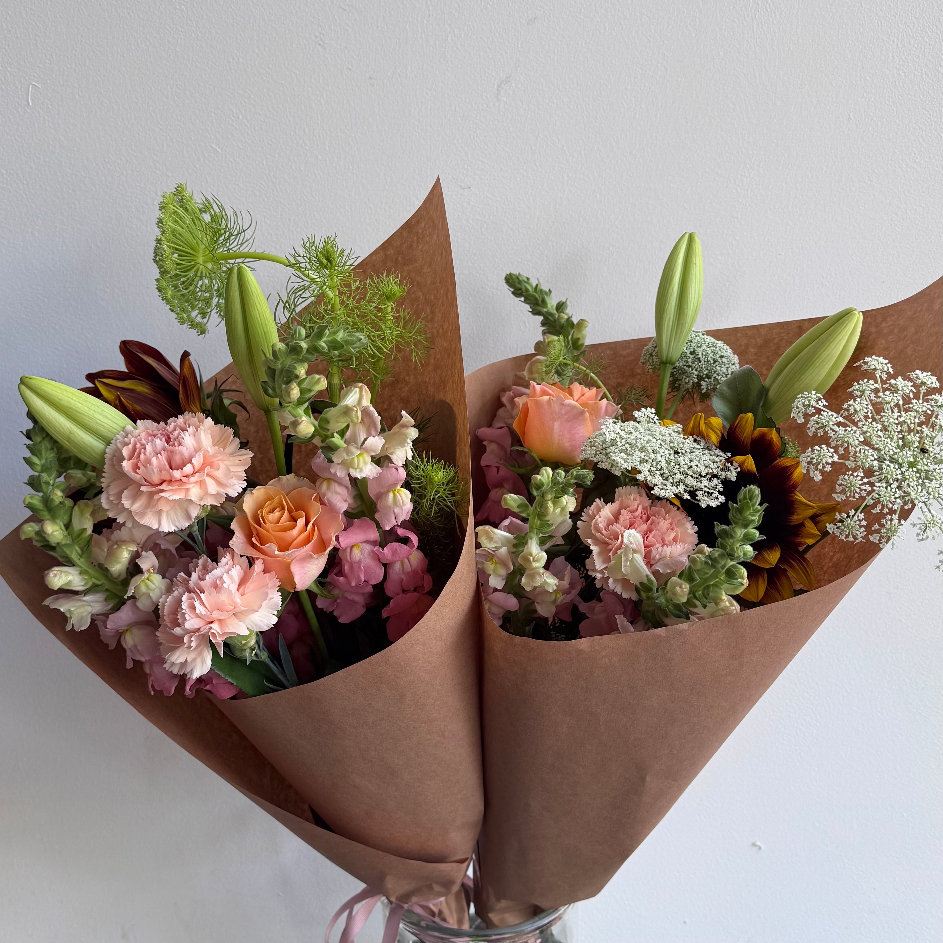 Soft pretty flowers in pinks and white wrapped in Kraft paper. Designed by Bendigo Florist Blumetown. 