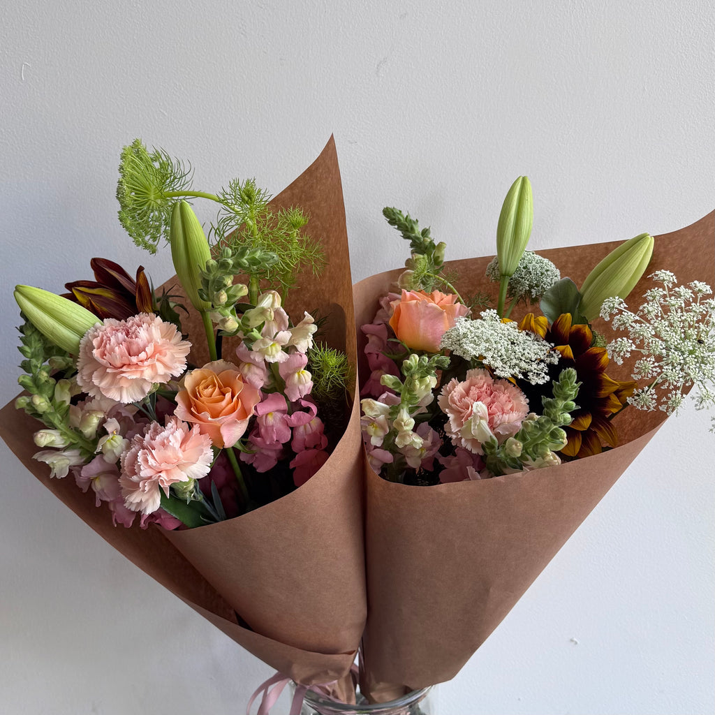 Soft pretty flowers in pinks and white wrapped in Kraft paper. Designed by Bendigo Florist Blumetown. 