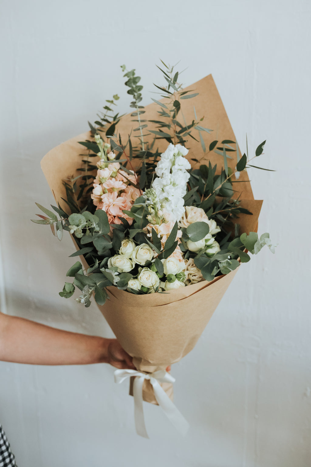 Soft pastel seasonal flowers in Bendigo wrapped in white paper and tissue. Compostable wrap and paper. Bendigo Florist. 